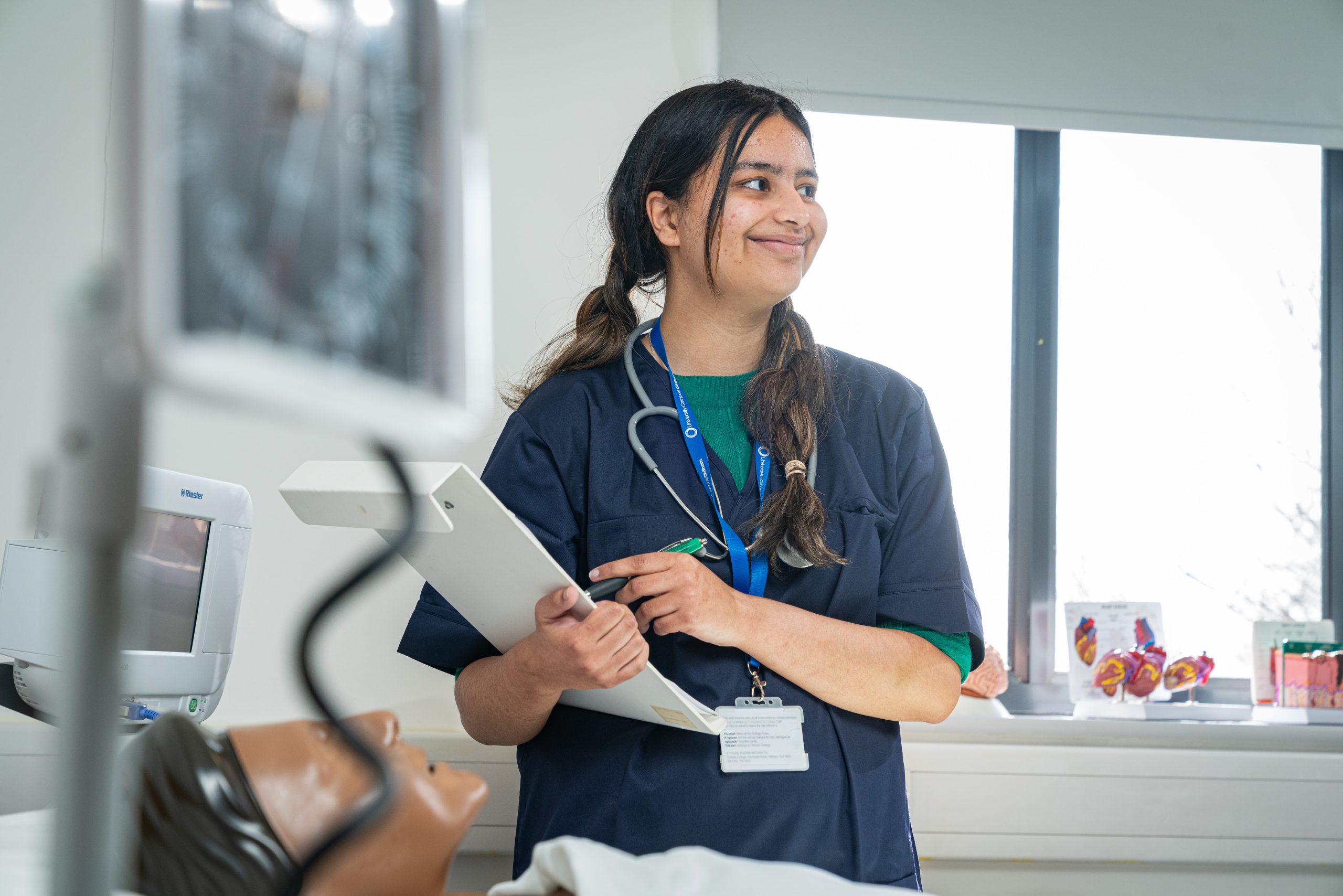 Female health and social care degree student holding a clipboard